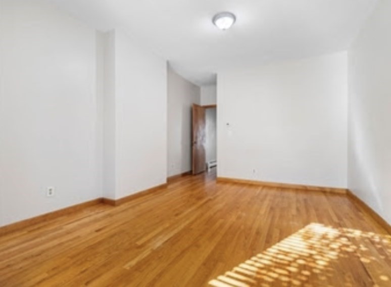 156 Lexington Street, Unit 1 Boston, MA 02128 - Photo 10 of 12 a view of empty room with wooden floor