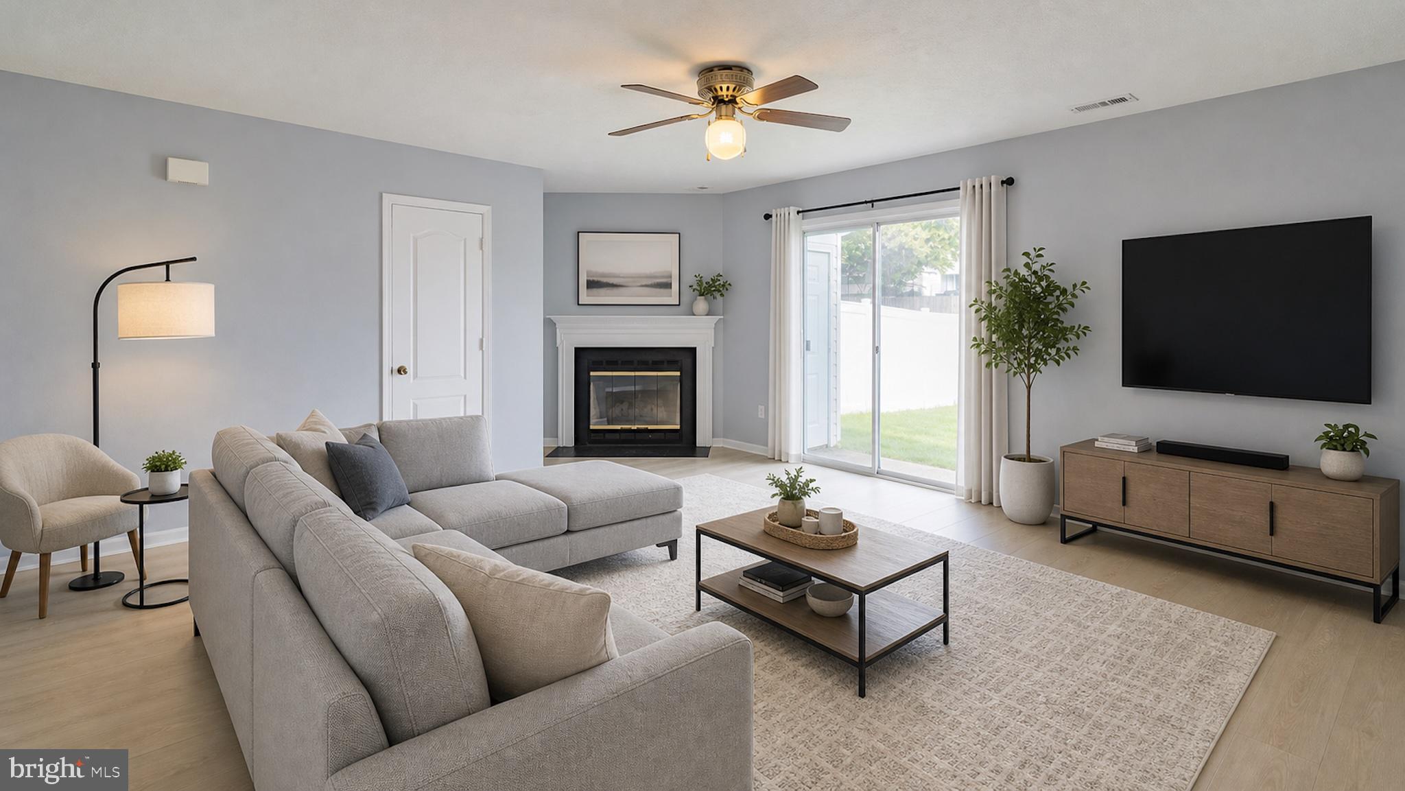 45292 Rumsford Lane California, MD 20619 - Photo 4 of 18 a living room with furniture a flat screen tv and a fireplace