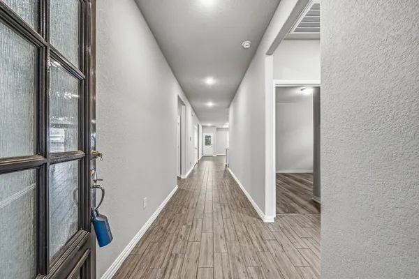 a view of hallway with wooden floor