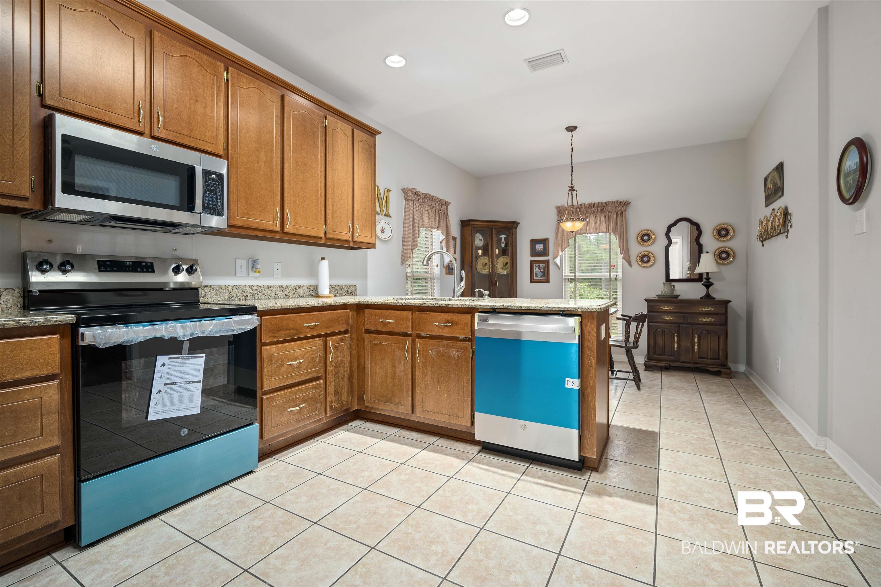 7419 Pake Road Saraland, AL 36571 - Photo 7 of 27 Kitchen with decorative light fixtures, light tile patterned flooring, sink, and appliances with stainless steel finishes