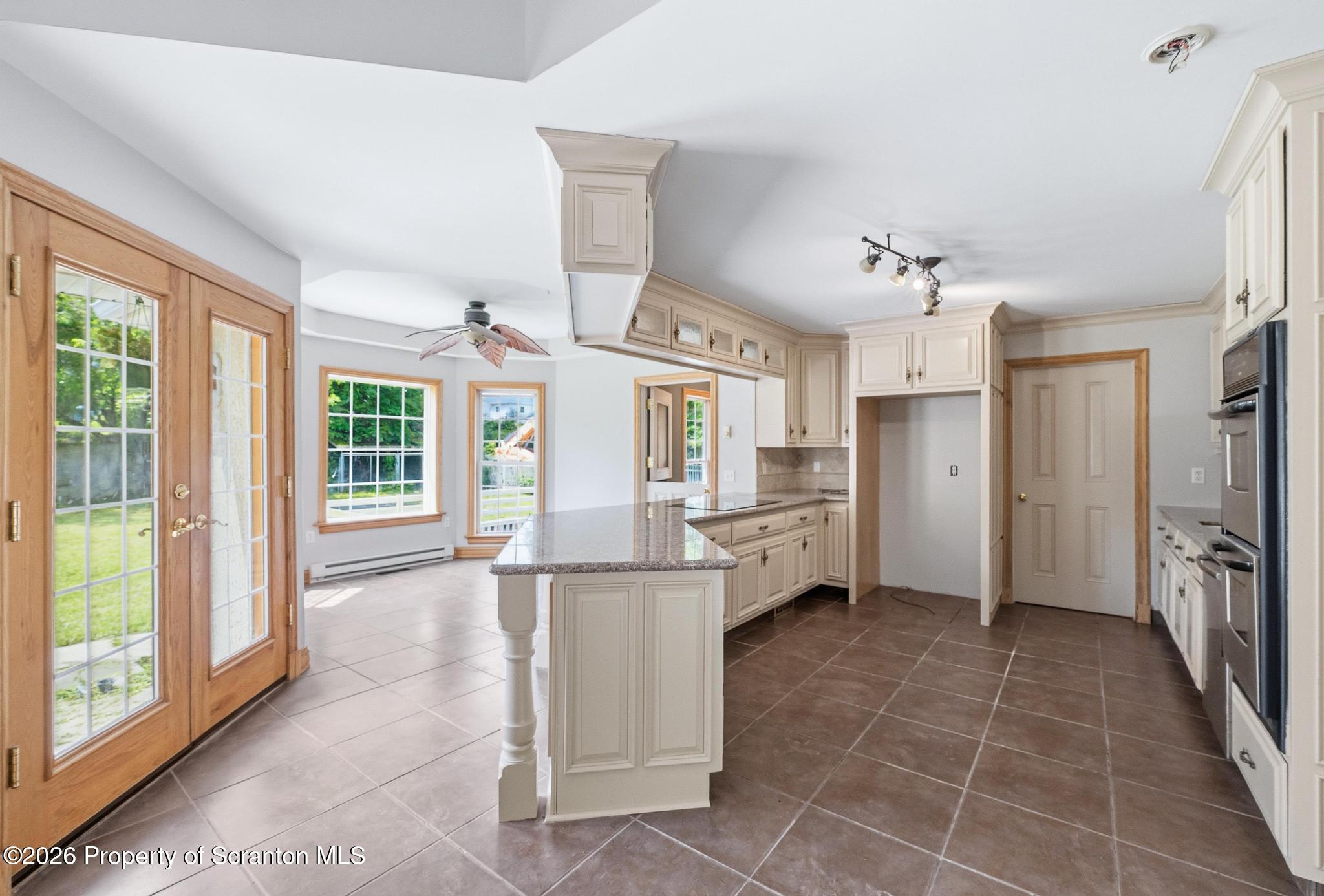 116 Forge Street Old Forge, PA 18518 - Photo 7 of 49 a kitchen with stainless steel appliances kitchen island granite countertop a refrigerator and a sink