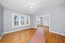 543 East 77th Street, Unit 2 Chicago, IL 60619 - Photo 4 of 6 a view of empty room with wooden floor and fan