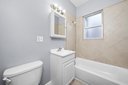 543 East 77th Street, Unit 2 Chicago, IL 60619 - Photo 6 of 6 a white bath tub sitting next to a white toilet
