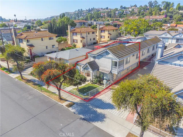 an aerial view of a house with a yard basket ball court and outdoor seating