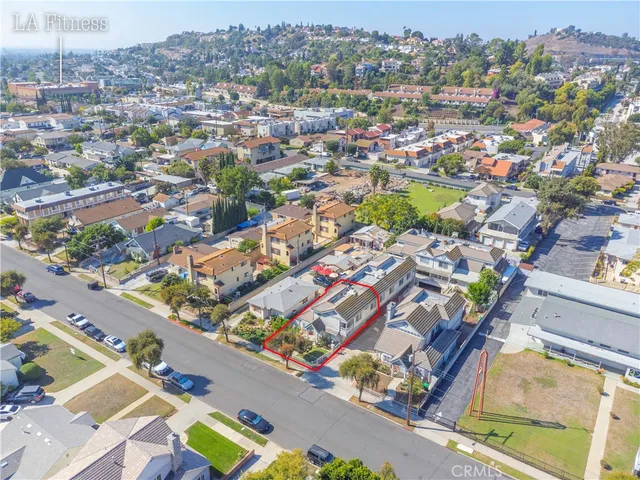 an aerial view of residential houses with outdoor space