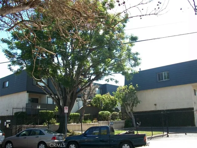 a street view with couple of cars parked on road