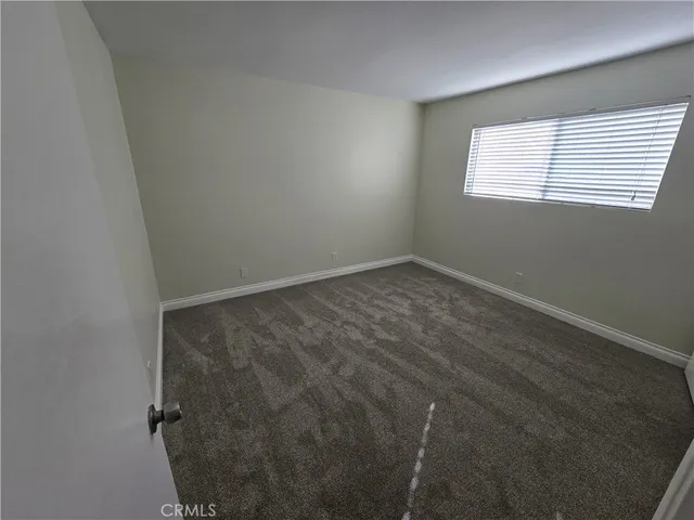 a view of an empty room and a window