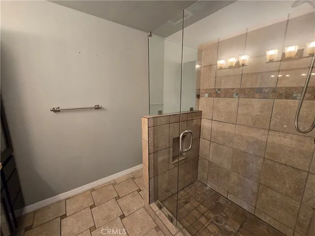 a bathroom with a granite countertop sink and mirror