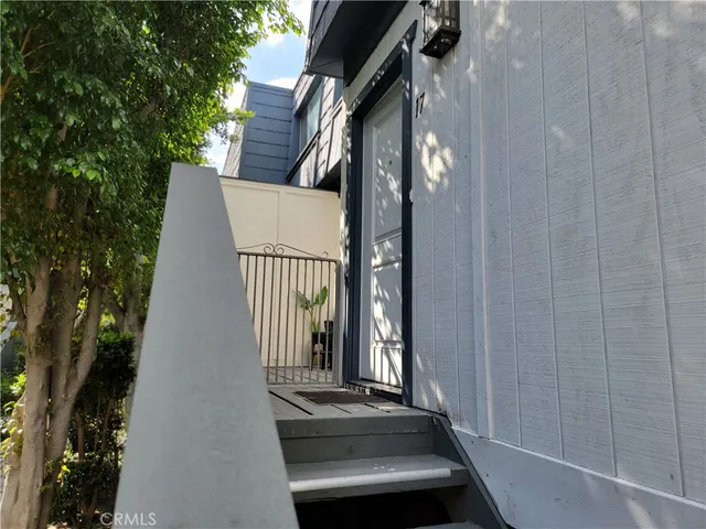 a view of staircase with wooden door and glass door