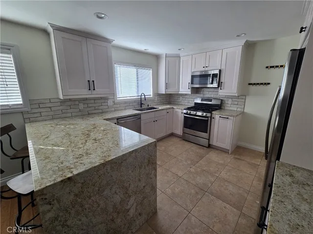 a kitchen with a sink stove and cabinets