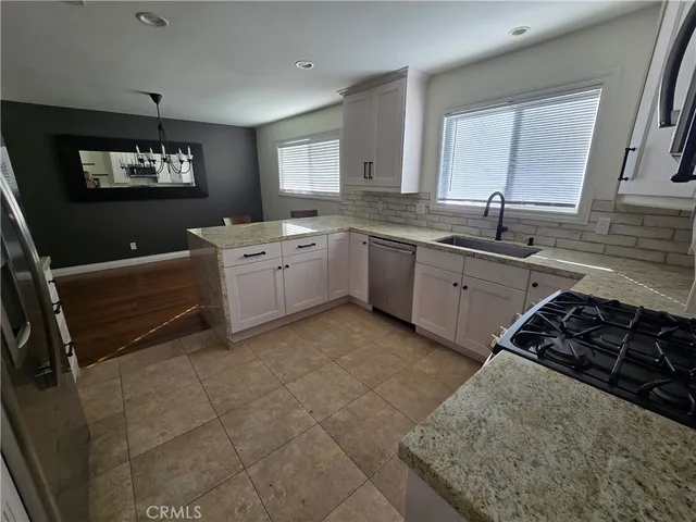 a kitchen with a sink stove and window
