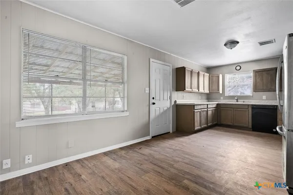 a view of a kitchen with a sink cabinets and a window