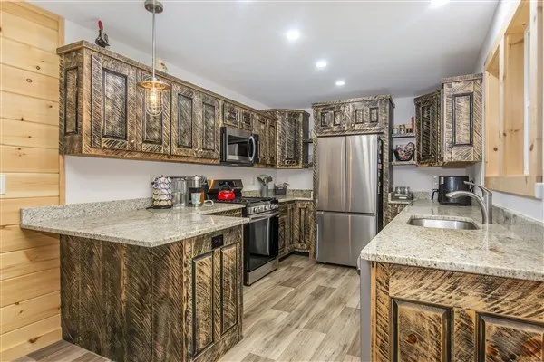 a kitchen with stainless steel appliances granite countertop a sink stove and refrigerator