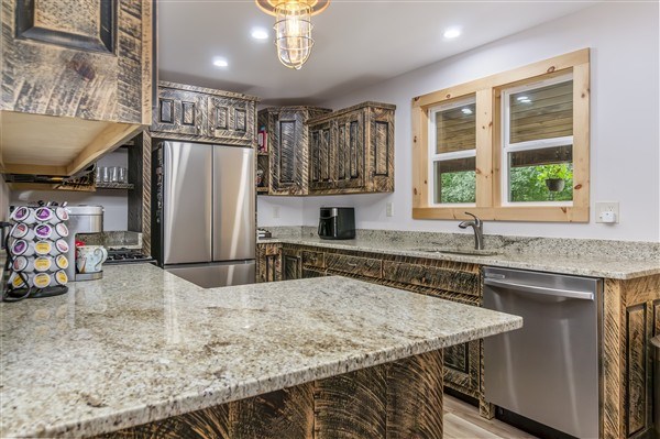 1519 Tipton Springs Road Morganton, GA 30560 - Photo 19 of 46 a kitchen with stainless steel appliances granite countertop a sink stove and refrigerator