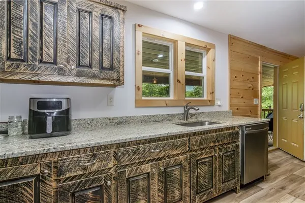 a kitchen with stainless steel appliances granite countertop a stove and a sink