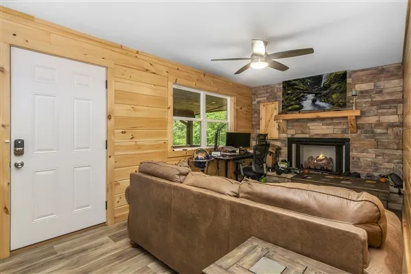 a living room with furniture a fireplace and a flat screen tv
