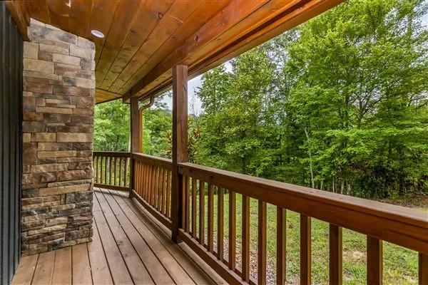 a view of a balcony with chairs and wooden fence
