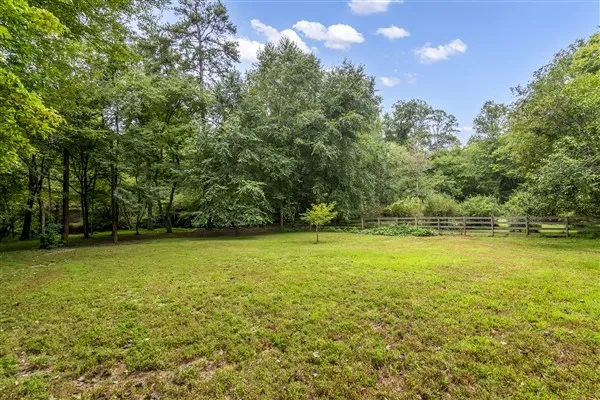 a view of a wooden fence and trees