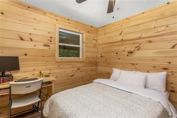 a bedroom with a bed and a desk