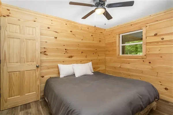 a bedroom with a bed and a window