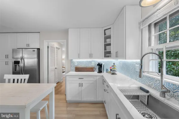 a kitchen with a sink stove and refrigerator