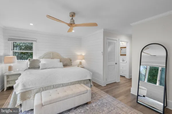 a bedroom with a large bed and a window