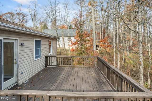a view of balcony with wooden floor and fence