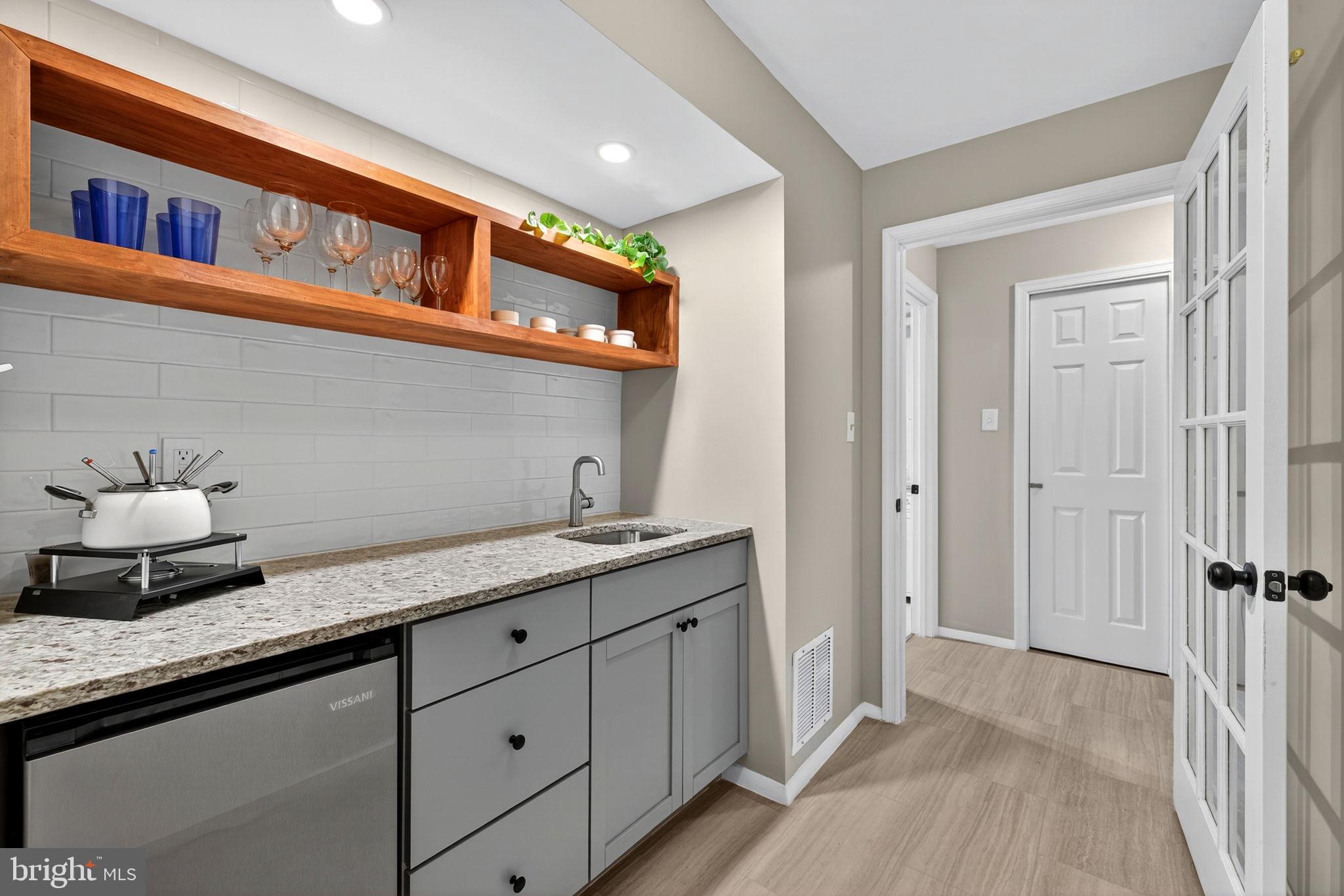 6517 Orono Court Springfield, VA 22152 - Photo 19 of 64 a hallway with cabinets a sink and wooden floor