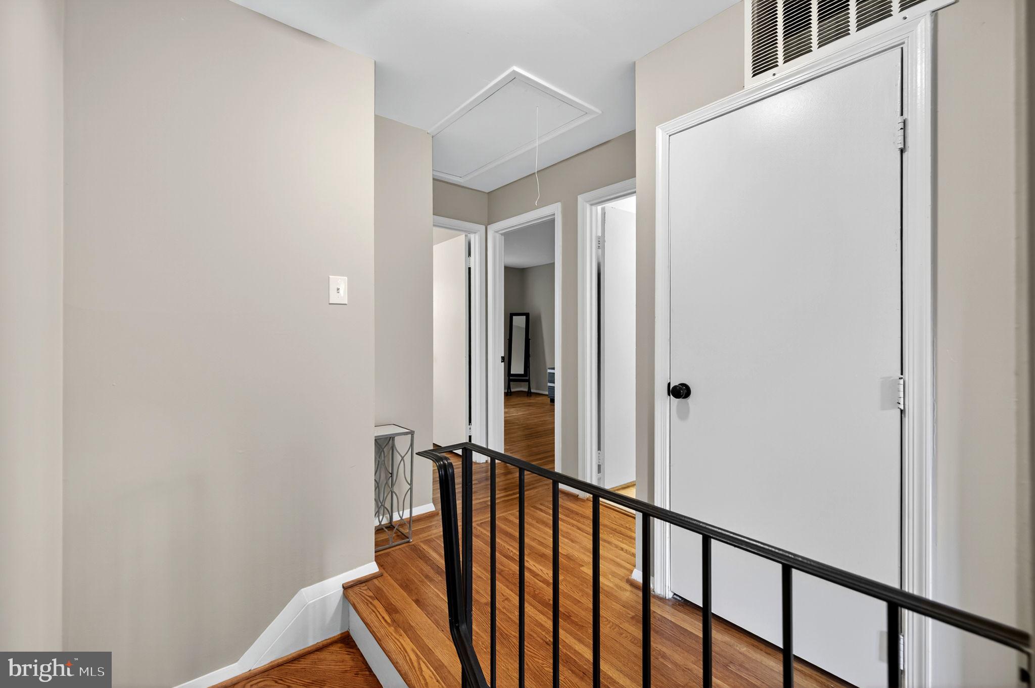 6517 Orono Court Springfield, VA 22152 - Photo 35 of 64 a view of a hallway with wooden floor and staircase