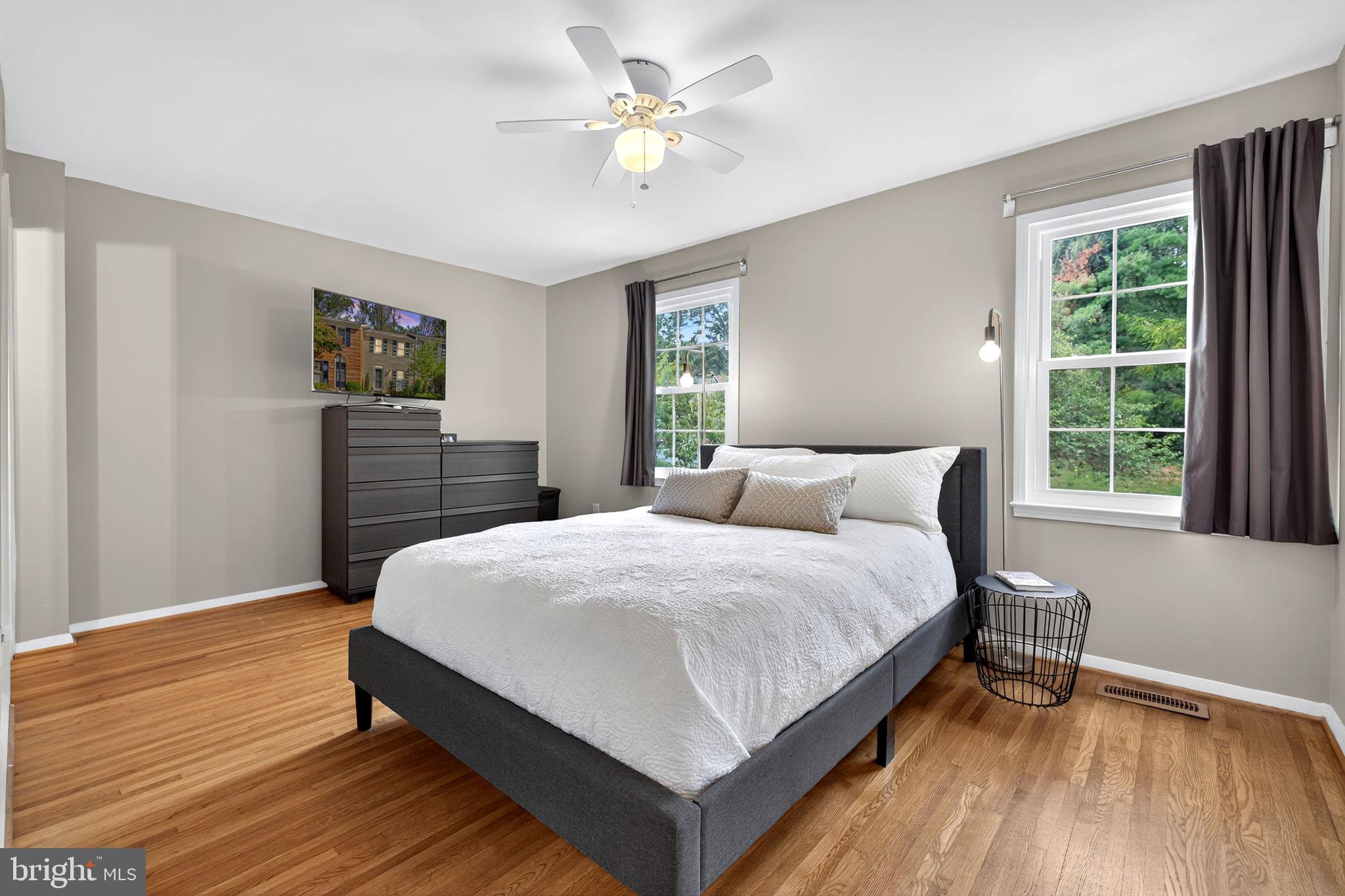 6517 Orono Court Springfield, VA 22152 - Photo 38 of 64 a bedroom with a bed and dresser with wooden floor