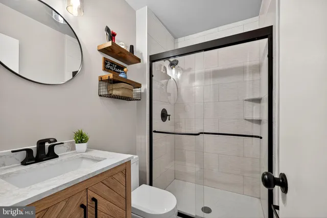 a view of a backyard with plants and wooden fence