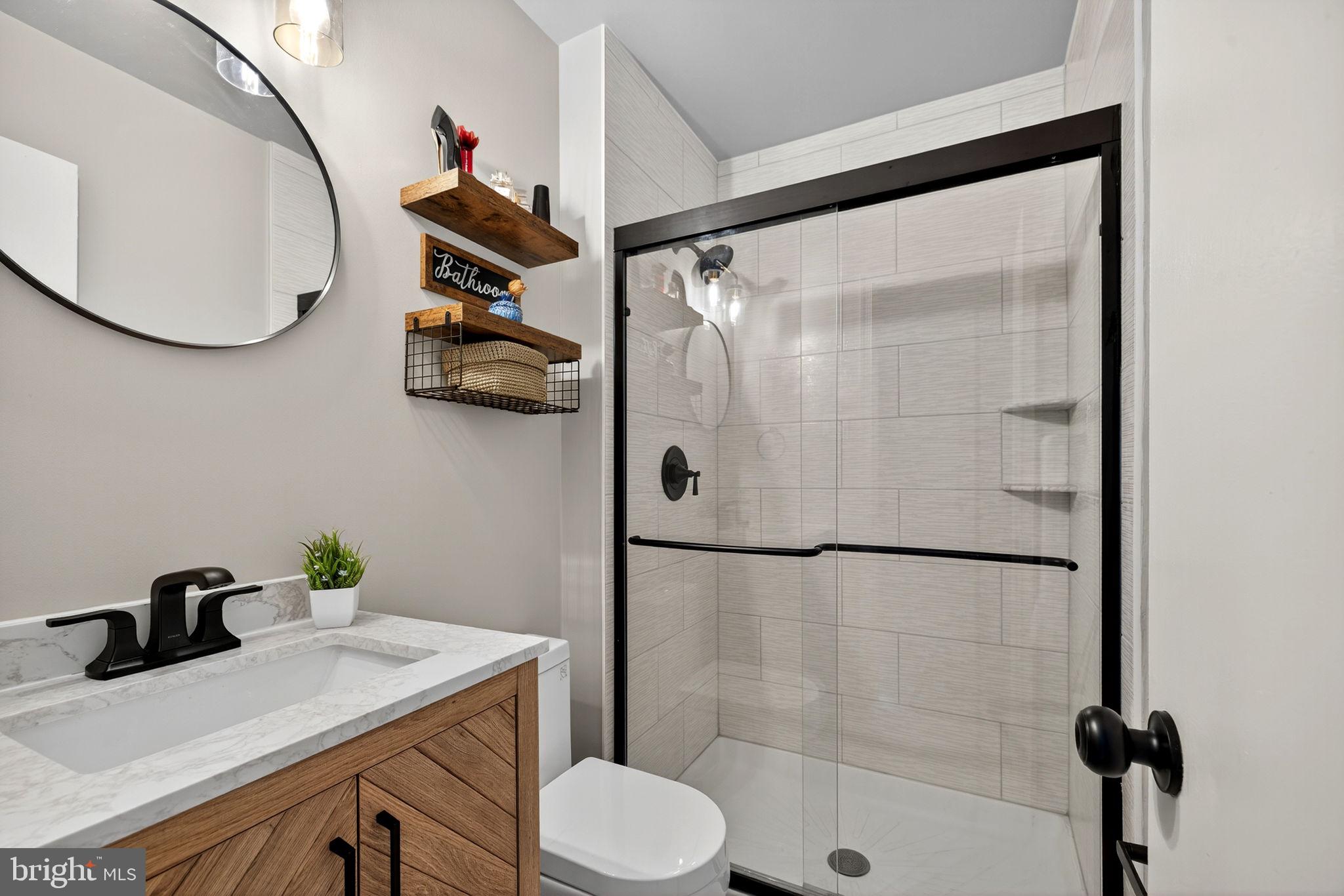 6517 Orono Court Springfield, VA 22152 - Photo 39 of 64 a bathroom with a sink toilet and shower