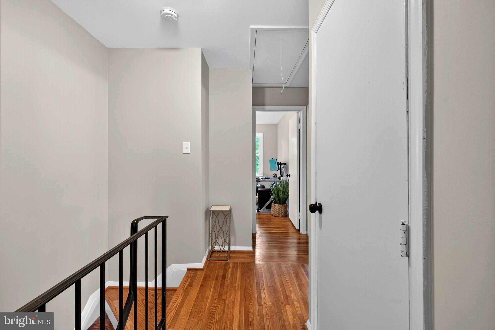 6517 Orono Court Springfield, VA 22152 - Photo 41 of 64 a view of a hallway with wooden floor and staircase