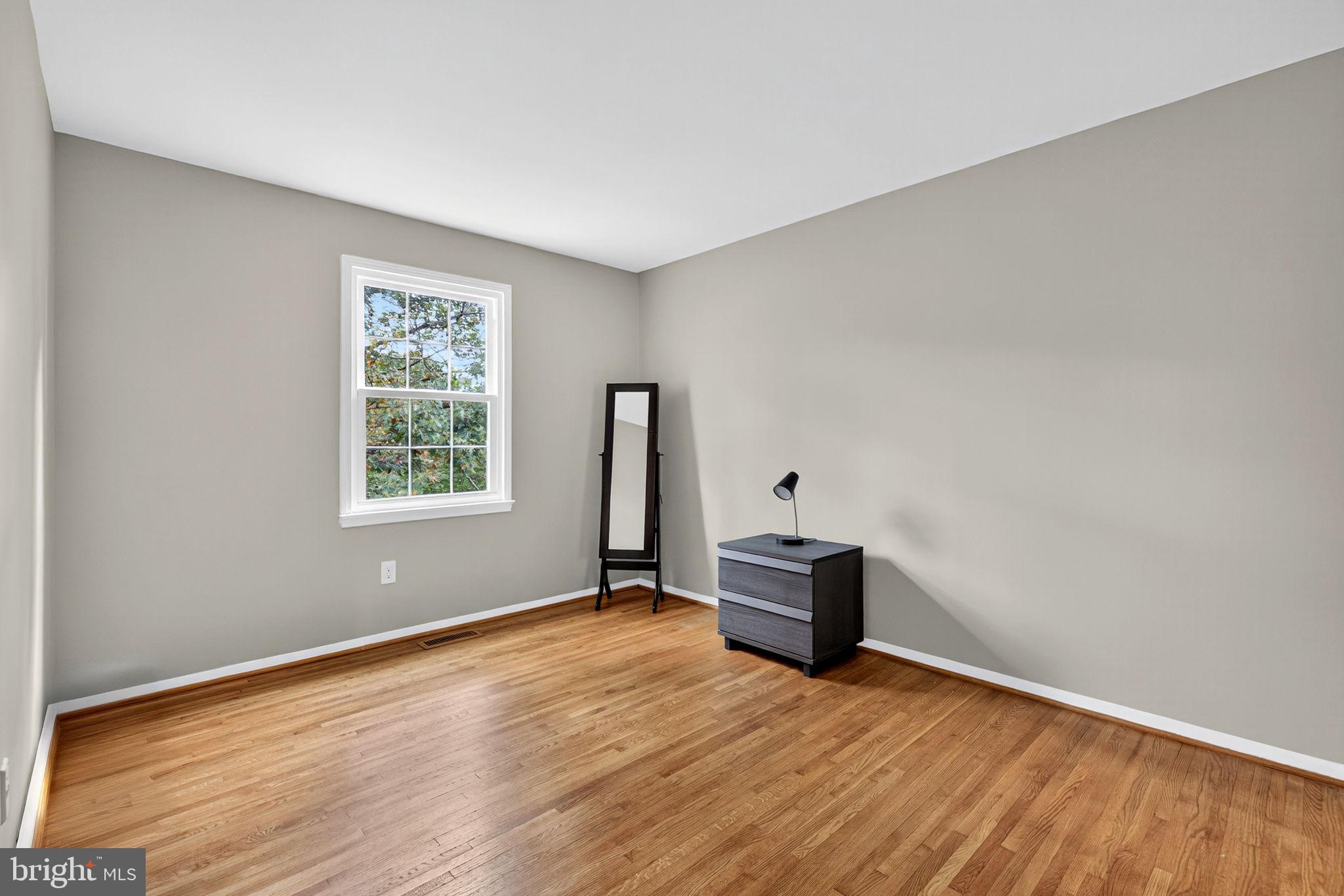 6517 Orono Court Springfield, VA 22152 - Photo 48 of 64 an empty room with wooden floor and windows