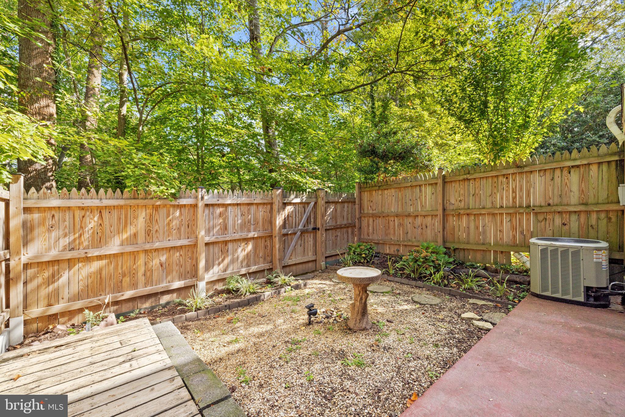 6517 Orono Court Springfield, VA 22152 - Photo 49 of 64 a view of a backyard with plants and wooden fence