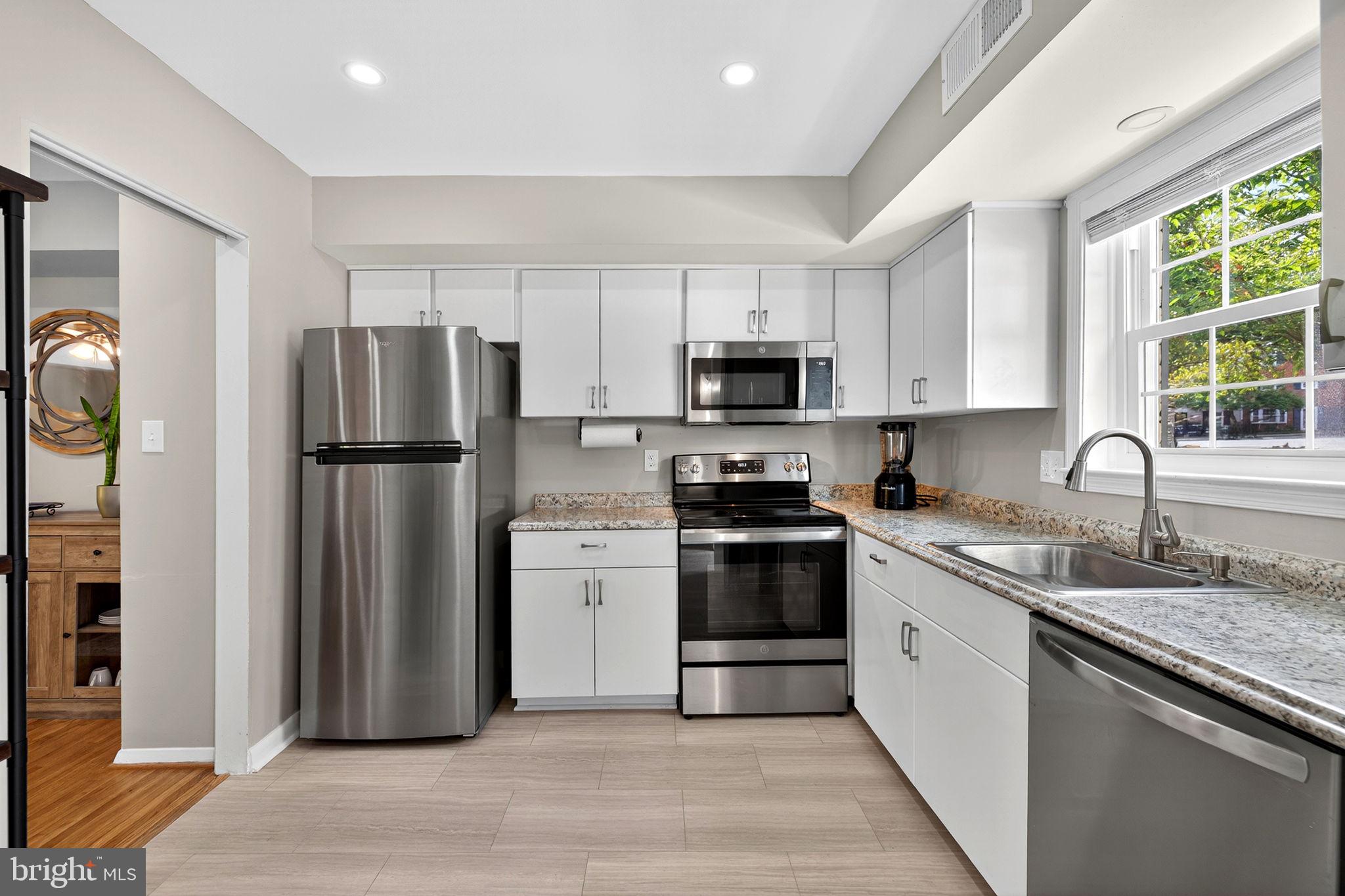 6517 Orono Court Springfield, VA 22152 - Photo 9 of 64 a kitchen with stainless steel appliances granite countertop a refrigerator stove microwave and sink