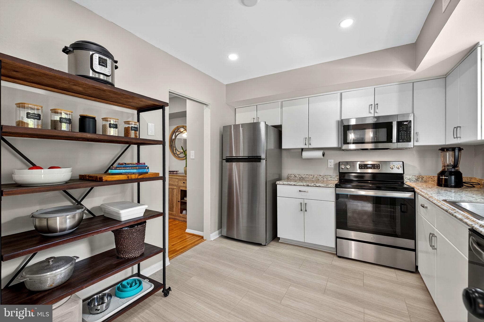 6517 Orono Court Springfield, VA 22152 - Photo 10 of 64 a kitchen with stainless steel appliances a refrigerator stove and sink