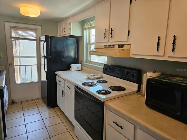 a kitchen with a sink cabinets and utility