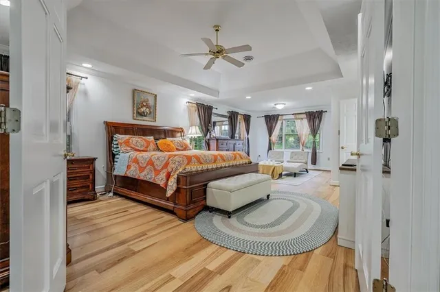 a bedroom with a bed couch and a window