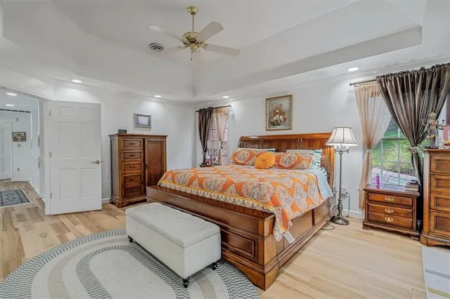a spacious bedroom with a bed couch and a window
