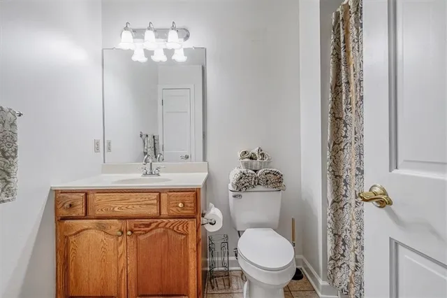 a bathroom with a toilet a sink and a mirror