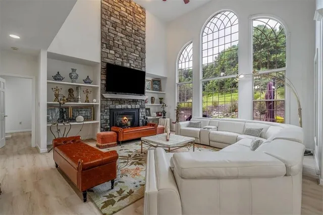 a living room with fireplace furniture and a flat screen tv