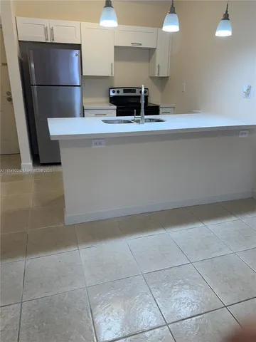 a view of a kitchen counter space and wooden floor