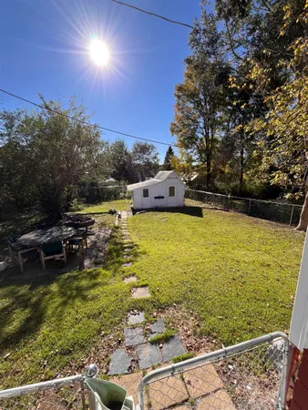 a view of a swimming pool with an outdoor seating and a yard