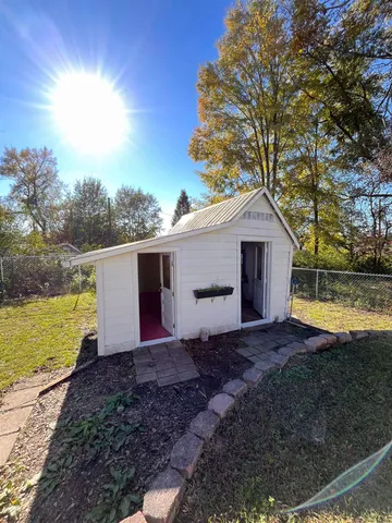 a view of a house with a yard and ocean view