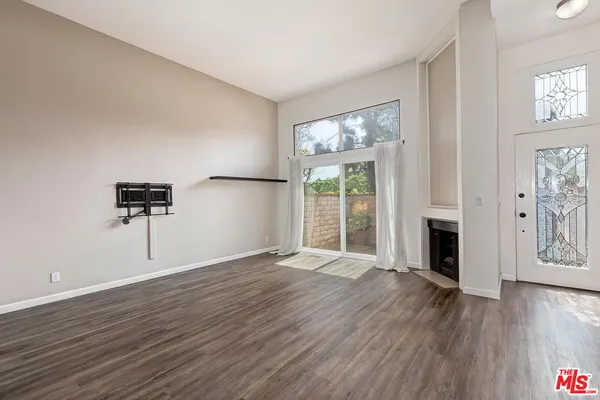 wooden floor fireplace and natural light in room