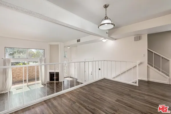 a view of an entryway with wooden floor