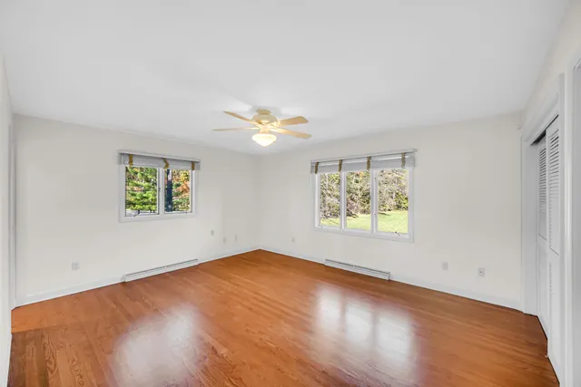 a view of backyard with seating space and trees in the background