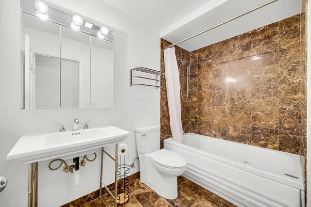 a bathroom with a bathtub and a toilet