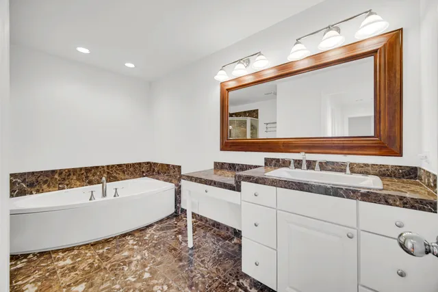 a bathroom with a sink toilet and a mirror